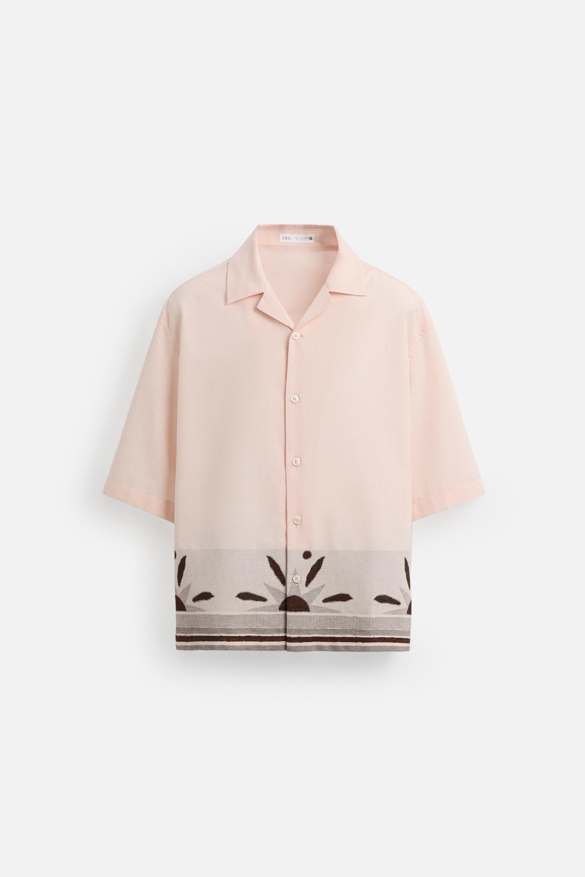 Insulated bottle with white base and black snap lid.